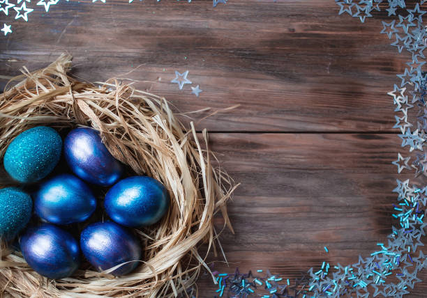 istock Blue Easter eggs in a nest on a wooden background. Easter card with a place to copy the text. The concept of bright Easter. 1388901856