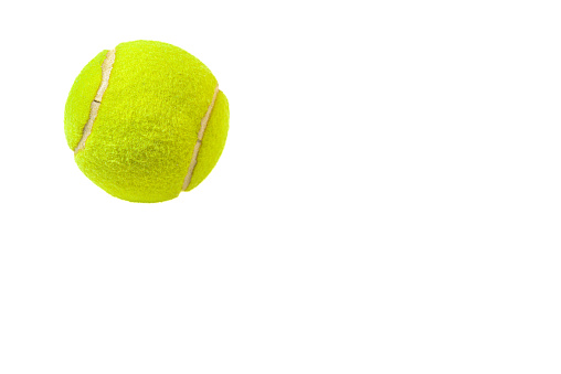 Tennis ball on a white background, in the upper left side. copy space