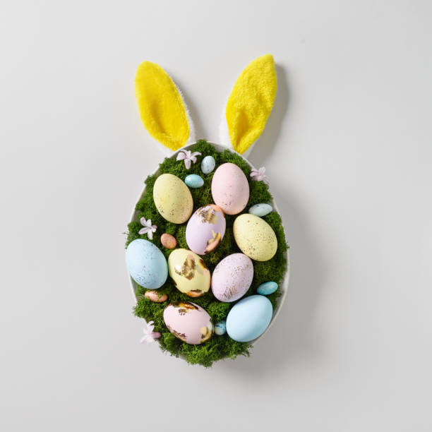 istock Easter DIY composition in plate for festive table set with rabbit , eggs, moss, and spring flowers. 1388905579