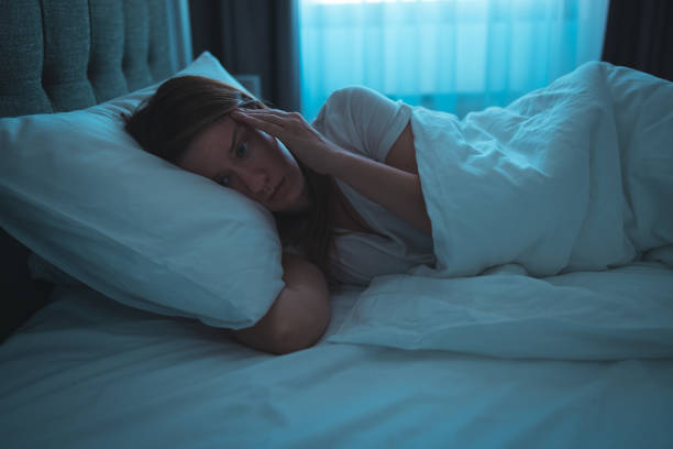 istock Woman with insomnia lying in bed with open eyes. 1388906864