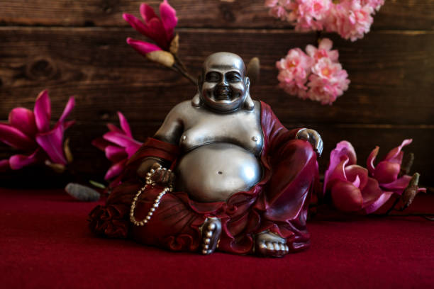 Fat happy laughing cozy buddha with flowers
