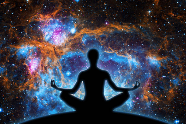 istock Yoga Figure Against Cosmic Nebula 1388907027