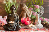 istock Buddha in the ambience with candlelight and atmospheric lighting 1388907059
