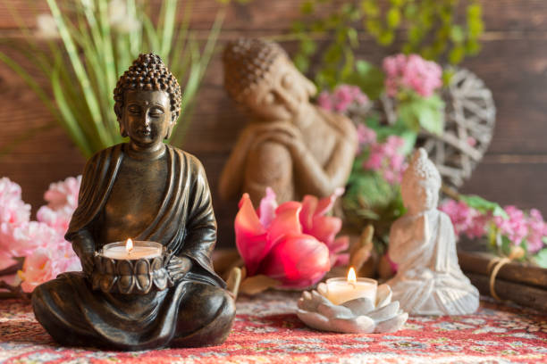 Buddha in the ambience with candlelight and atmospheric lighting stock photo