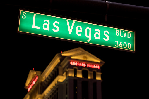 Las Vegas, USA - Sep 22, 2019: A Las Vegas blvd street sign early in the evening with the Caesars hotel in the background.