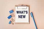 istock WHAT'S NEW - words written in a notebook. Question for Social media, Blog post. Top view image of notebook and with many paper clips and blue pen on beige background 1388909214