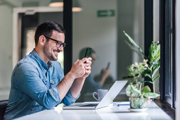 istock Merry adult man, browsing the internet, on mobile. 1388911898