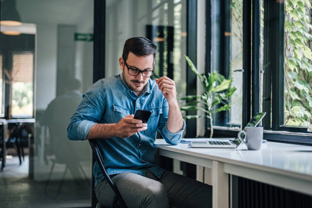istock Serious caucasian man with glasses, getting a message on phone. 1388912279