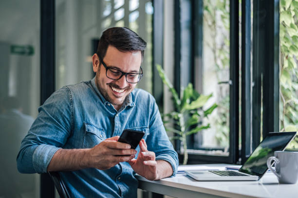 istock Smiling caucasian man, getting a lovely message on his phone. 1388912297