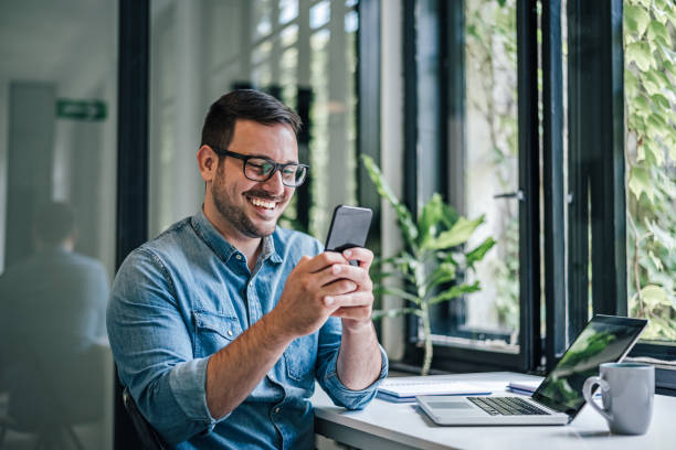 istock Smiling caucasian man, getting a surprising message on his phone. 1388912375