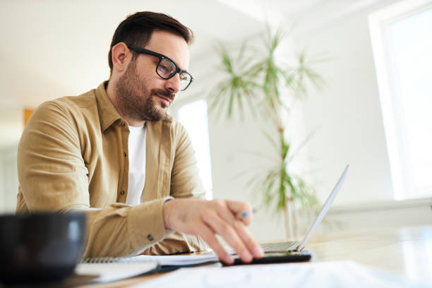 istock Young male entrepreneur working at home office. 1388913232