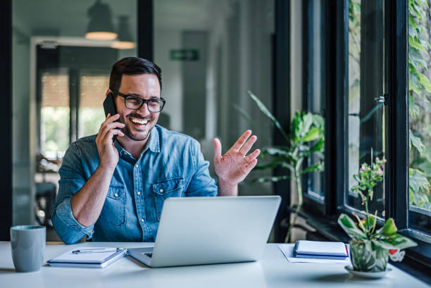 istock Merry office worker, receiving a surprising phone call. 1388913292