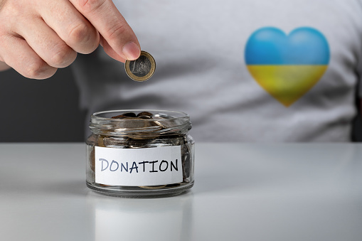 Donation for Ukraine concept. Help and financial assistance to Ukraine. donation jar with Ukrainian flag. donation for ukrainian refugees. Donation for Ukraine concept.