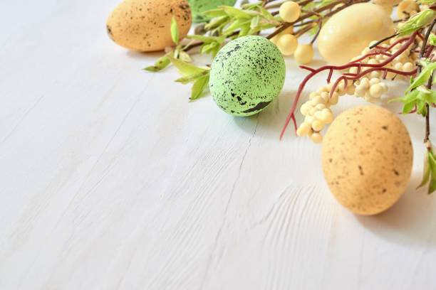 istock Branches with buds and green leaves, easter eggs on a light background. Happy easter concept with copy space 1388918274