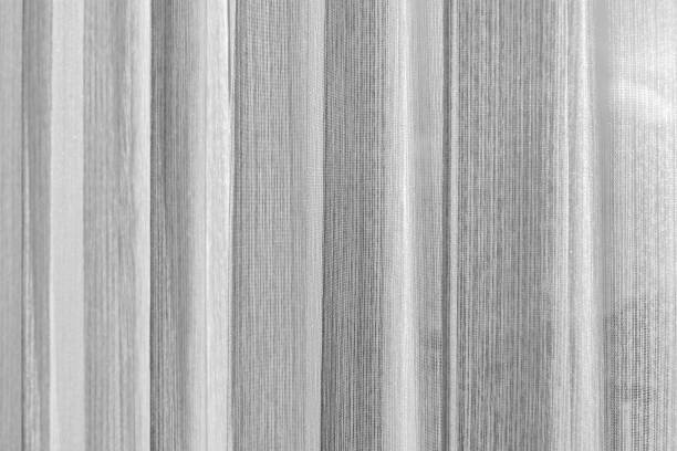 istock Wavy white tulle curtain. Background photo 1388919518