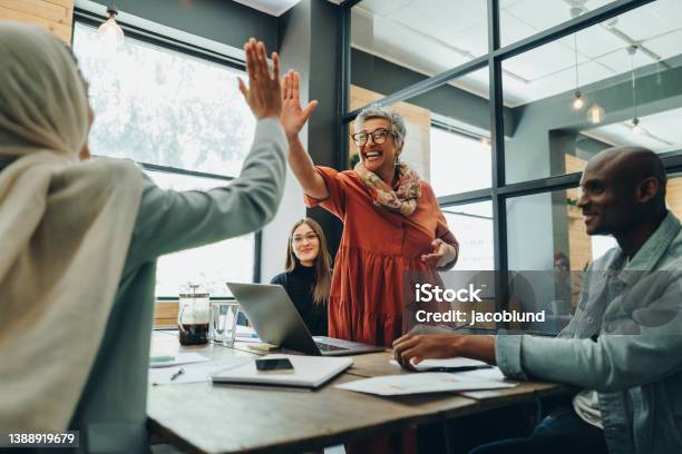 Two Cheerful Businesswomen Celebrating Their Success Stock Photo - Download Image Now