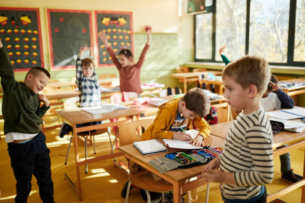 istock Carefree school kids having fun on a break in the classroom. 1388919725