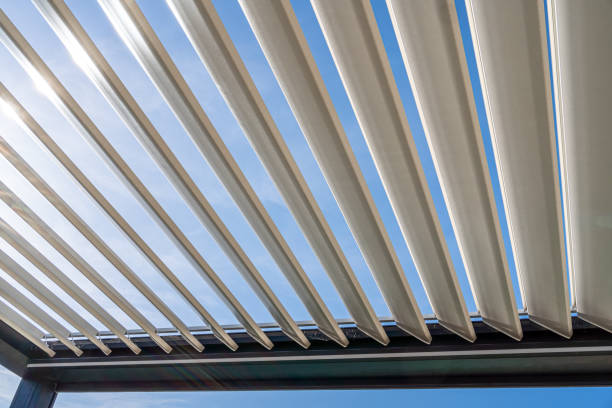 istock Trendy outdoor patio pergola with sun's rays passing through the metallic structure 1388919821