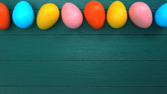 Colored Easter eggs on the green table. 3d illustration.