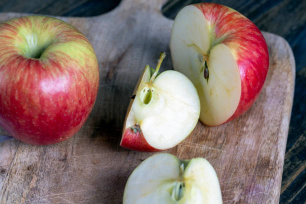 istock cutting old board with pieces of red ripe apple 1388920536