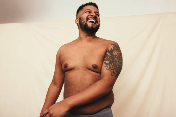 istock Tattooed man laughing cheerfully in a studio 1388920588