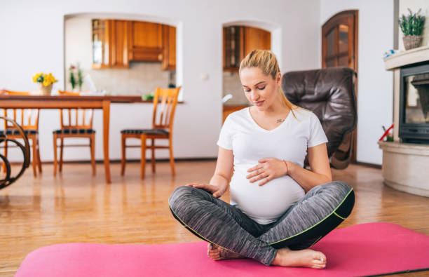 istock Pregnant woman practicing yoga at home 1388920675