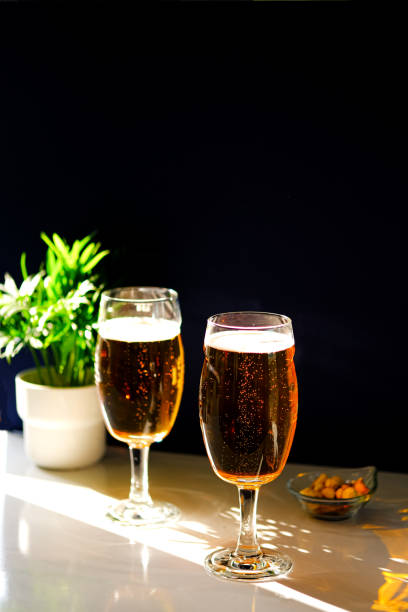 istock Two glasses of light beer on the table. 1388920837