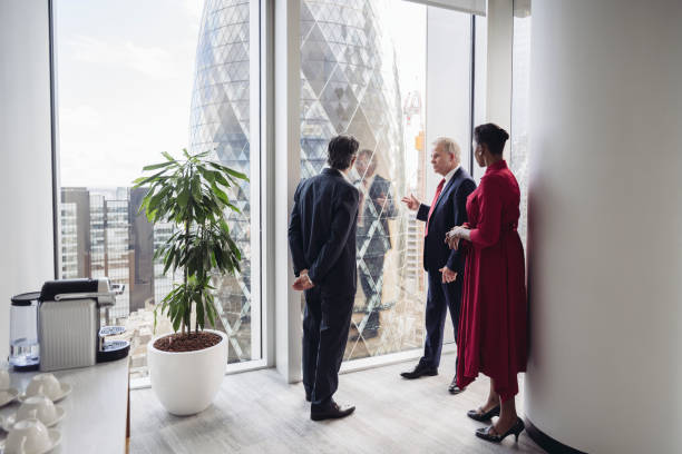 istock Business colleagues looking out window at financial district 1388921697