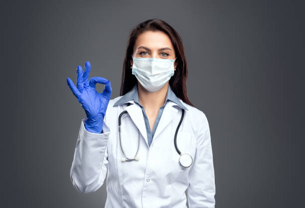 istock Medical specialist in protective mask showing okay gesture 1388922737