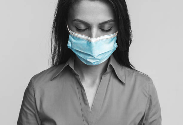 istock Sad woman in surgical mask 1388922774