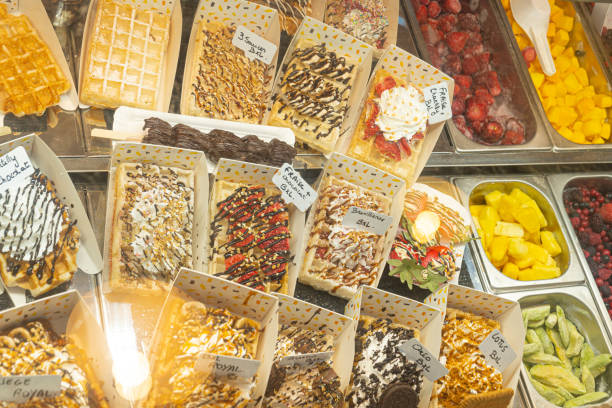 Belgian waffles with colorful toppings on showcase. Brussels stock photo