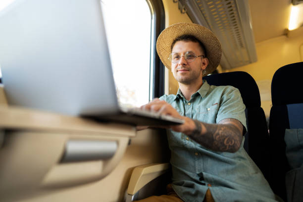 istock Caucasian man, working on laptop while travel with train 1388923608