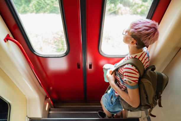 istock Curious female tourist looking through train window 1388923630