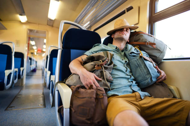 istock Caucasian male tourist,sleeping while travel with train, surrounded with few backpacks 1388924970