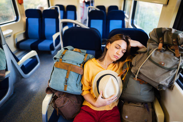 istock Female tourist,sleeping while travel with train, surrounded with few backpacks 1388924989