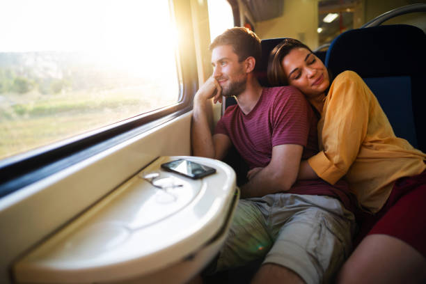istock Embraced young couple travel together with train 1388925025