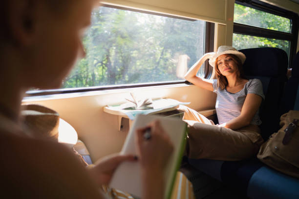 istock Creative woman, drawing her girlfriend while travel together 1388925200