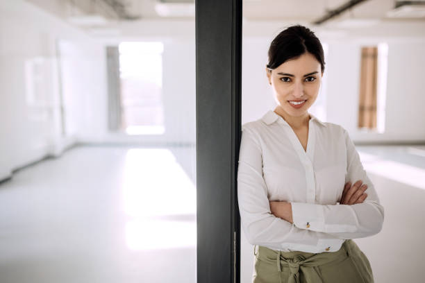 istock Confidant  smiling businesswoman posing in empty office 1388925617