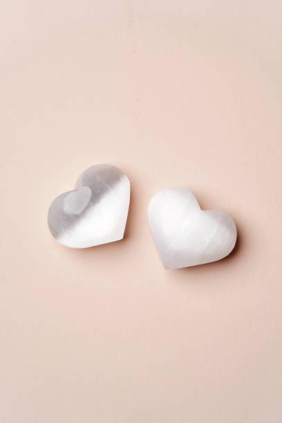 istock Heart shaped crystal stone on pink background 1388926362