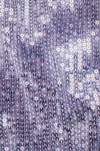 istock Pieces of cloth with silver sequins. Glitter background. Sequin texture 1388926421