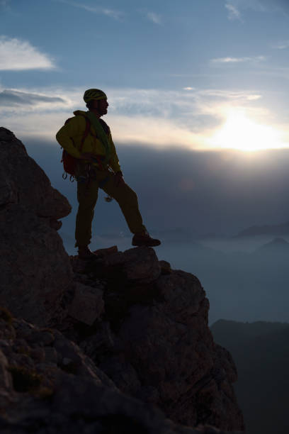 istock Silhouette of a mountain climber on a rock 1388927061