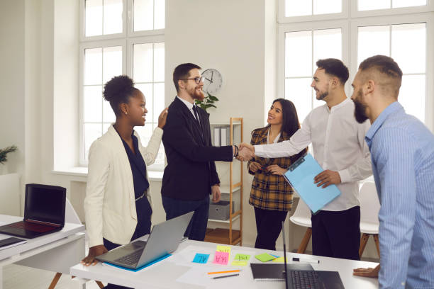 istock Team leader handshake employee congratulate with professional achievement 1388927145