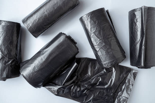 New black garbage bags on a white background.