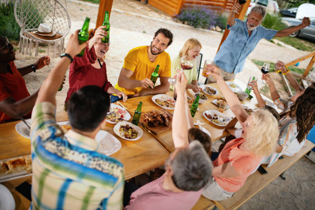istock Family and friends toasting with drinks during lunch. 1388928856