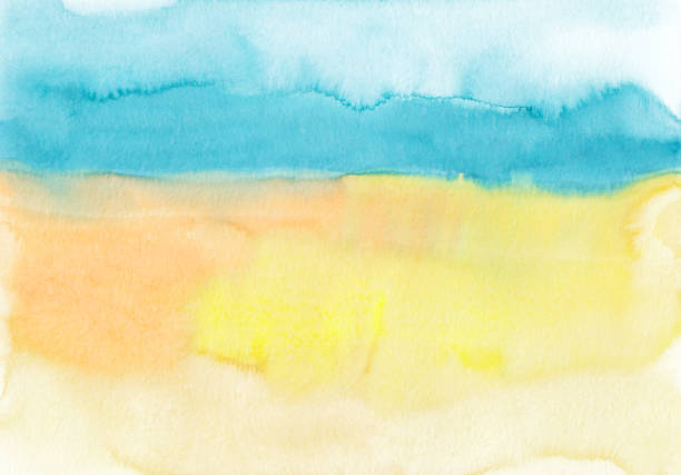 istock Watercolor blue, yellow and orange background texture, hand painted. Artistic backdrop, stains on paper. Aquarelle painting wallpaper. 1388929004