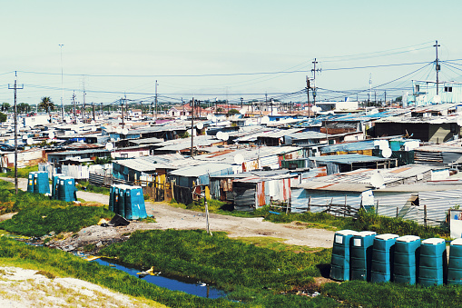 Roof tops of shack homes in a ghetto with electricity power lines