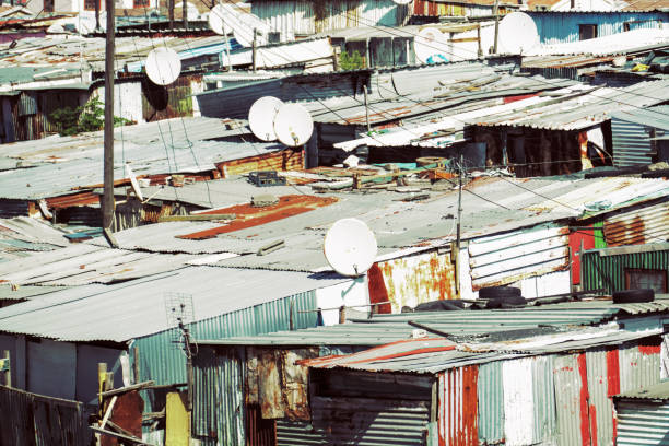 Roof tops of shack homes in a ghetto with electricity power lines
