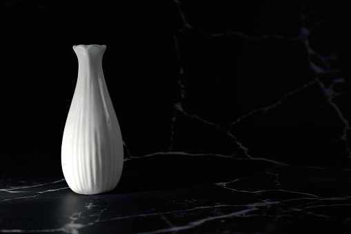 Vase on black marble background