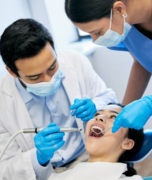 istock Shot of a dentist working on his young patient 1388931704