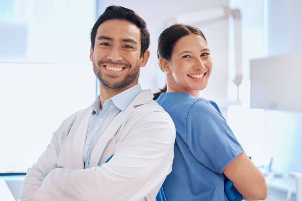 Shot of a young dentist with his assistant